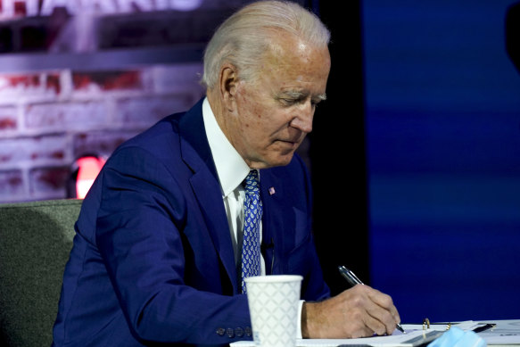 President-elect Joe Biden takes notes during a meeting with his COVID-19 advisory council on Monday.