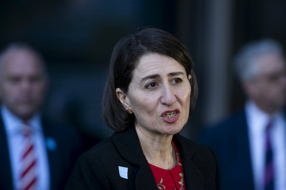 Premier Gladys Berejiklian, flanked by education officials, announces a gradual return to classrooms