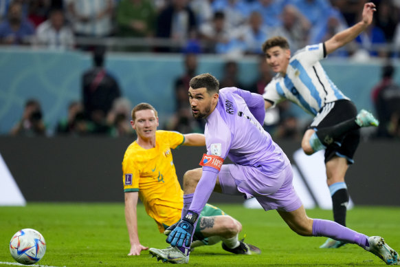 Australia’s goalkeeper Mathew Ryan, center, fails to stop Argentina’s Julian Alvarez’s shot.