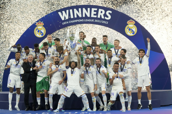 Real Madrid’s Marcelo lifts the trophy after winning the Champions League final soccer match against Liverpool.