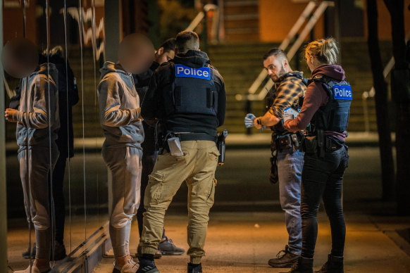 Police question a young man as part of Operation Alliance.