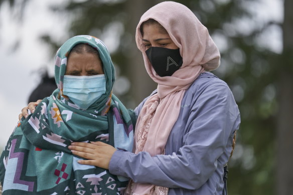 Khalida Ashram and her daughter Anila mourn at the scene of an attack on Monday, involving a driver accused of plowing a ute into an immigrant family of five in London, Ontario.