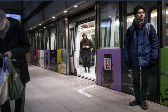 Passengers stand at the Noerreport Metrostation in Copenhagen Denmark.