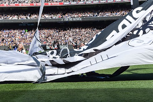 Tragedy: Collingwood’s 2018 grand final banner was blown apart by the wind before the players ran through. West Coast won that flag.