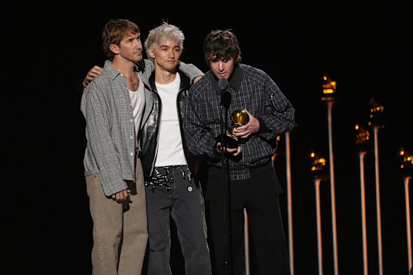 From left, Turnstile’s Pat McCrory,  Daniel Fang, and Brendan Yates accept the award for best rock album for Never Enough at this year’s Grammy Awards.