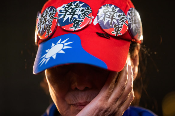 A Kuomintang supporter covers her face. Her party's pro-Beijing presidential candidate was defeated easily by the pro-independence incumbent. 