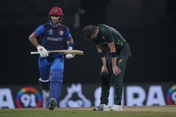 Pakistan’s Shaheen Afridi, right, reacts as Afghanistan’s Rahmat Shah run between the wickets. 