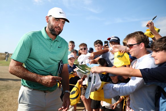 USA's Scottie Scheffler signs autographs for fans ahead of the Open Championship at Royal Birkdale. 