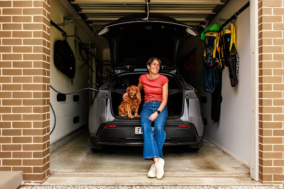 Bronwyn Batten with her electric vehicle, the biggest single expense in getting off fossil fuels.