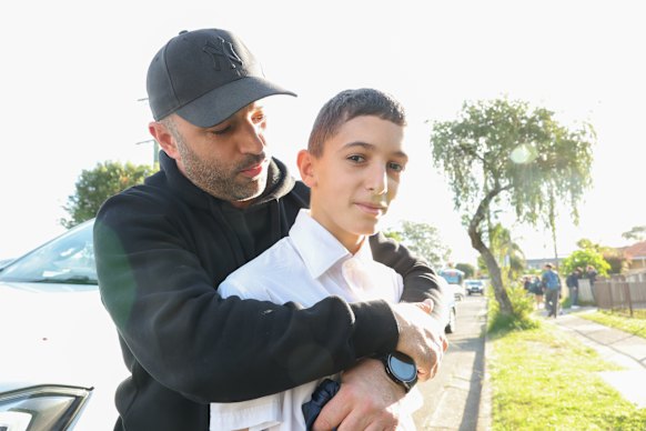 “It’s a bit scary”: Giulio Buda with his son Domenico during the school pick-up on Wednesday afternoon.