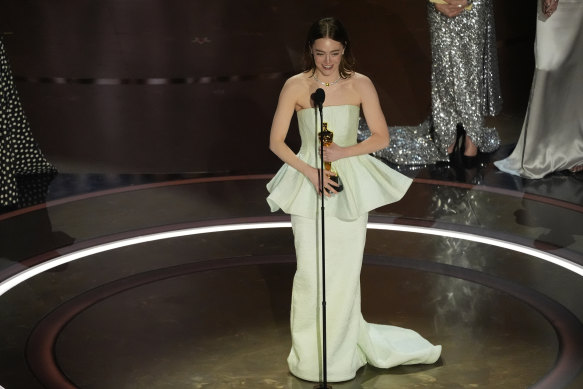 Emma Stone accepts the award for best performance by an actress in a leading role for Poor Things during the Oscars.