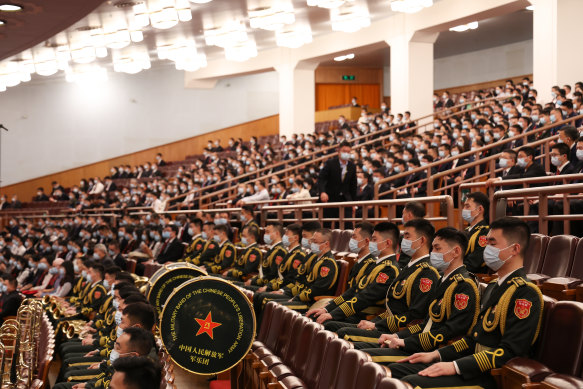 Members of the People’s Liberation Army (PLA) band sit during the opening session of the 20th National Congress.