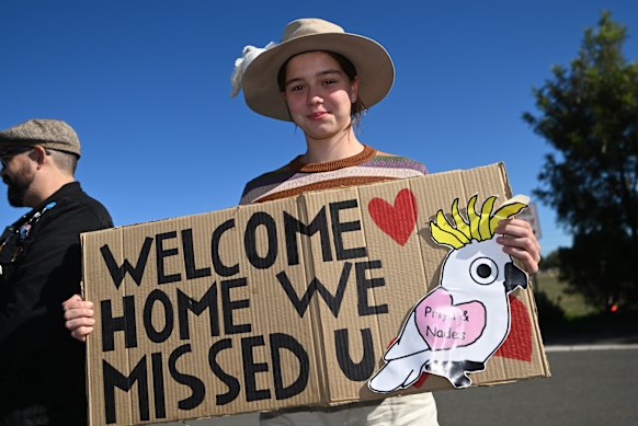 Isabelle Kelleher holds a welcome sign ahead of the Murugappan family’s return to Biloela.