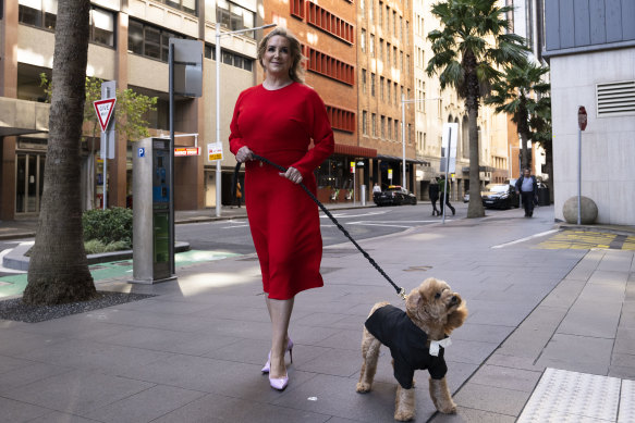 Gina Edwards and Oscar the cavoodle outside court before the judgment.