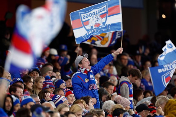 A Bulldogs fan waves a flag.