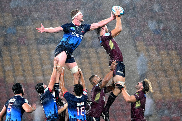 Angus Blyth of the Reds and Ross Haylett-Petty of the Rebels fly high during a lineout.