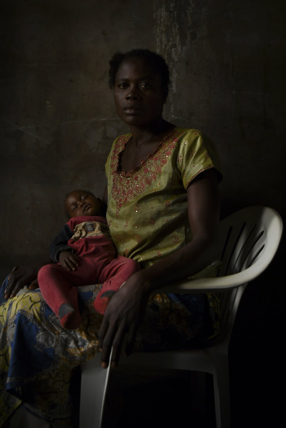 Bibisha Malu, 29, holds her daughter Cristine, who is the result of rape. She was held captive for one year and three months.