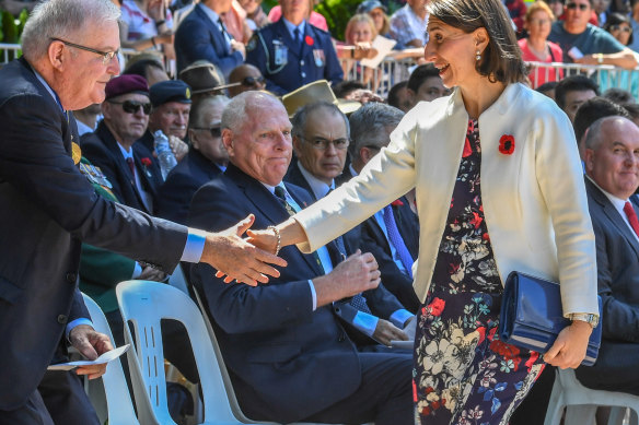 Premier Gladys Berejiklian in floral skirt with poppies.