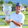 Karl Vilips of Australia poses with the winner’s trophy.