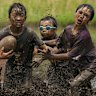 Participants play rugby in a muddy rice field in Fujimi, Saitama Prefecture, Japan. Teams competed in the event, with the winner determined by the combined scores of all matches. Four-player rugby matches held in rice fields before the planting season have been gaining popularity in Japan as a form of community engagement and regional revitalisation.