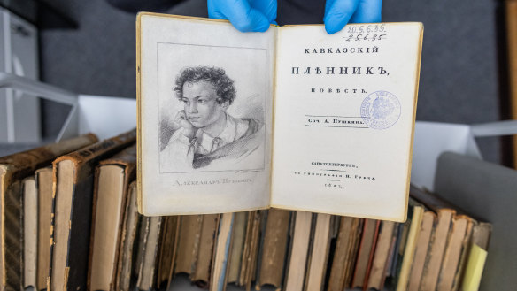 A university employee presents a fake copy of a first edition of the 1822 book ‘Kavkazskiy plennik: povest’ by Alexander Pushkin at the University of Warsaw library in Poland.