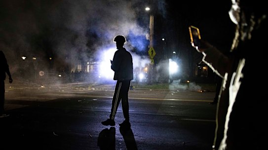 Protesters confronts with police in front of the Brooklyn Centre Police station.