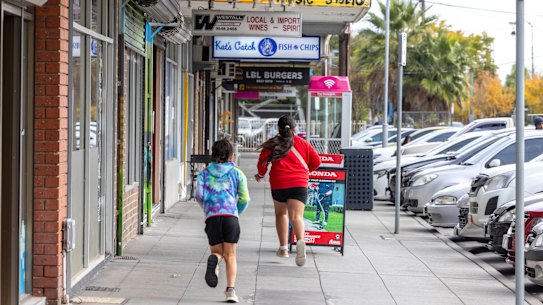 Children running along the Rosebank Avenue shopping strip in Clayton South.