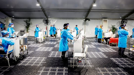 Workers at the Histopath pre-departure COVID testing clinic at Sydney International airport.