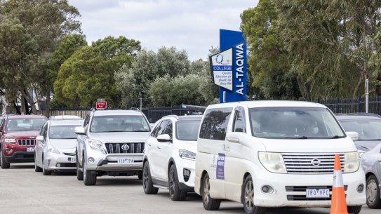 Cars queue at the pop-up testing clinic at Al-Taqwa College on Thursday morning. Eligible candidates are also being offered a dose of the Pfizer COVID-19 vaccine. 