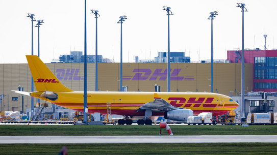 A cargo airplane of the DHL package delivery company stands on the tarmac at Leipzig/Halle Airport in Schkeuditz, Germany, on Tuesday.