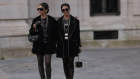  Twins Jyoti Babani, Snehal Babani are dressed in partner look, both seen wearing black jackets, black short dresses, black tights with Chanel logo, black boots with silver chain details, lots of silver chains from Chanel.