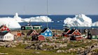 Brilliant white icebergs float close to shore at Qeqertarsuaq.
