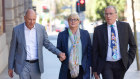 Former Minister Linda Reynolds arrives at the Perth Supreme Court for a mediation session with Brittany Higgins, flanked by husband Robert Reid (left) and lawyer Martin Bennett.