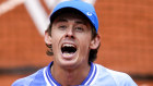 Alex De Minaur celebrates winning his fourth round match of the French Open tennis tournament against Russia’s Daniil Medvedev.