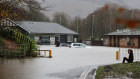 A view of flooding at Cross Keys Rugby Club in Newport, Wales that shows  three vehicles submerged in water on Sunday (Monday AEDT).