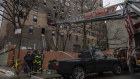 Emergency personnel work at the scene of a fatal fire at an apartment building in the Bronx.