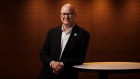 Greg Horan is stepping down as the chief executive of Healthscope and will be replaced by former Qantas executive Tino La Spina.