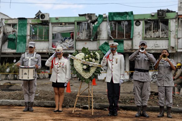 A military school band plays to honor people killed a day earlier by a car bomb explosion outside an Air Force base in Cali, Colombia.