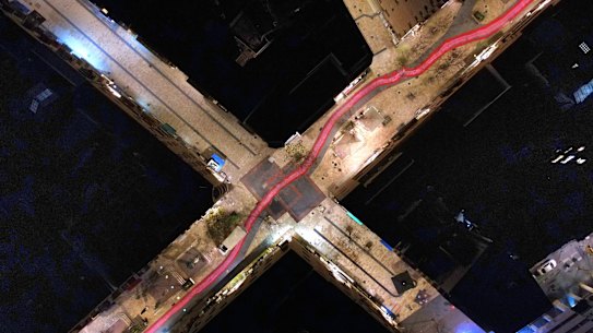 An aerial view of a road, which was painted with red and pink stripes, leading through Jerusalem to Israel’s Sumpreme Court.
