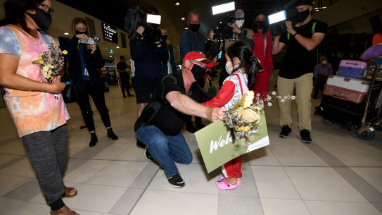 Stewart Maddison greets his granddaughter Maple and daughter Mai at Perth airport after Western Australia’s borders opened to domestic and international travellers. March 3 2022.