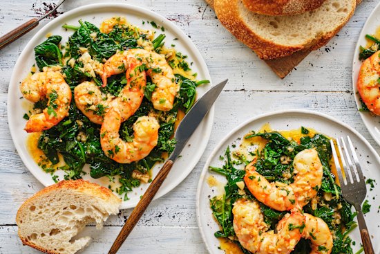 Garlic-butter and white-wine prawns over wilted spinach.