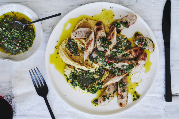 Grilled sausages on a bed of chickpea mash.