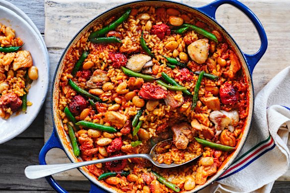 Cook the chicken and chorizo paella until the rice starts to crackle on the base of the pan.