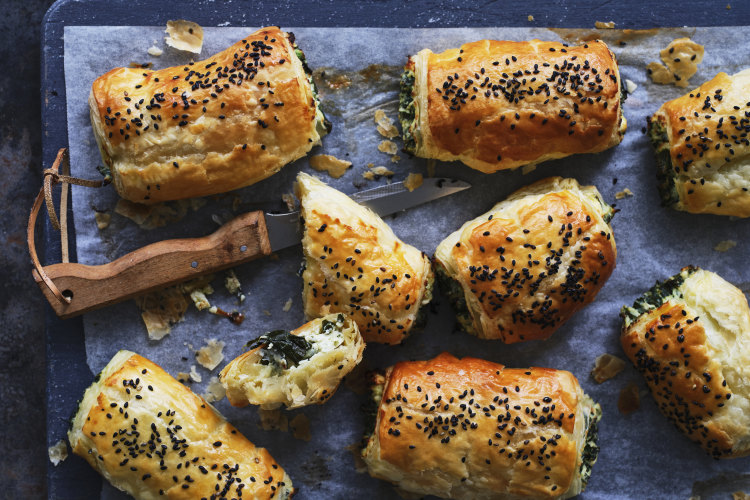 Kale and three-cheese pastries sprinkled with nigella seeds.