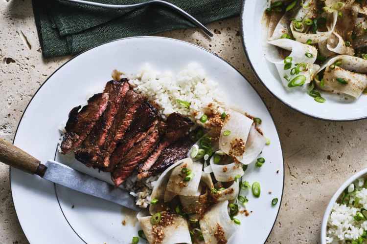 Marinated minute steaks with sesame daikon salad and steamed rice.