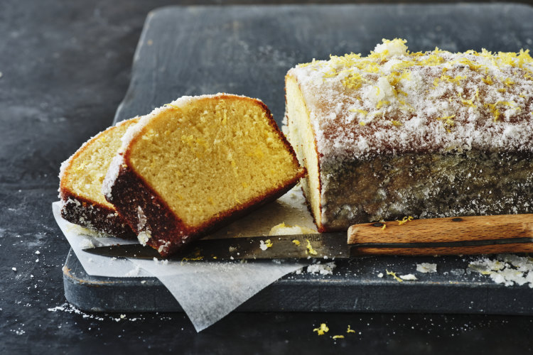 This lemon cake is briefly soaked in syrup and rolled in vanilla-lemon sugar to create a crust.