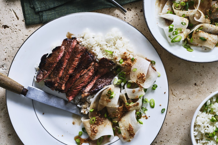 Marinated minute steaks with sesame daikon salad and steamed rice.