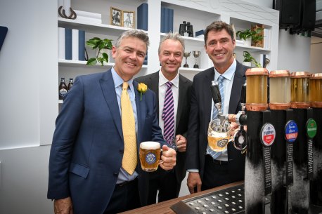 Furphy founders Adam Furphy and Sam Furphy pull a pint with Lion Nathan chief executive Sam Fischer at the Furphy marquee.  