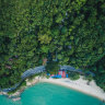 This tropical garden oasis faces a picturesque white-sand beach.