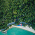 This tropical garden oasis faces a picturesque white-sand beach.